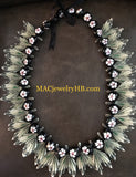 This lei is white flower with pink center kukui nut lei with 25 x $1.00 bills